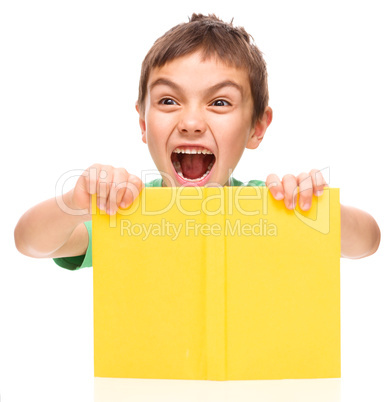 Little boy is holding a book