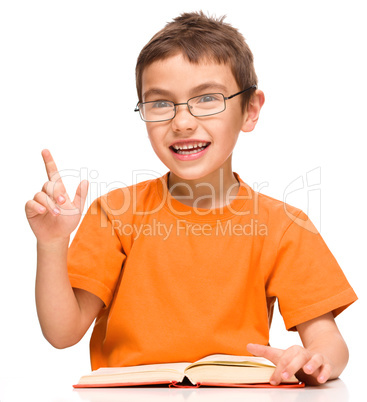 Little boy is reading a book