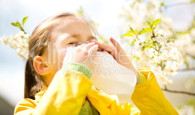 Little girl is blowing her nose