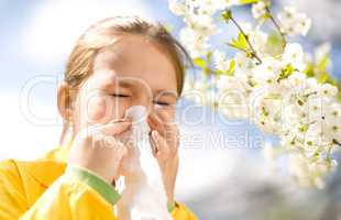 Little girl is blowing her nose