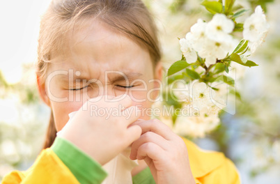 Little girl is blowing her nose