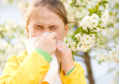 Little girl is blowing her nose