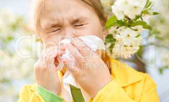 Little girl is blowing her nose