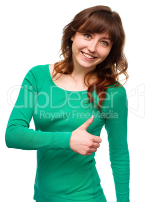 Woman is showing thumb up gesture