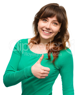 Woman is showing thumb up gesture