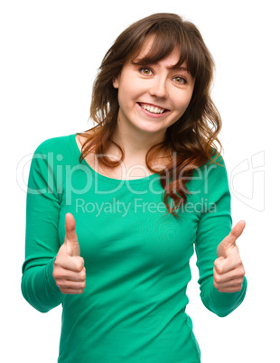 Woman is showing thumb up gesture