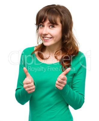 Woman is showing thumb up gesture