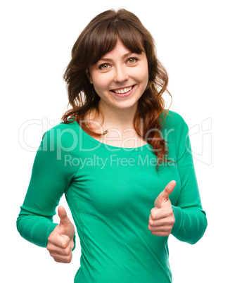 Woman is showing thumb up gesture