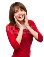 Woman is holding her face in astonishment