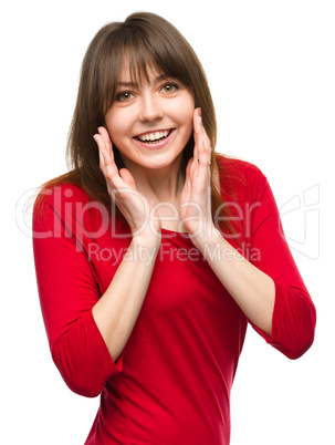 Woman is holding her face in astonishment