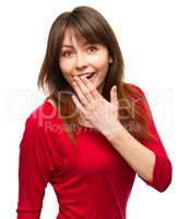 Woman is covering her mouth in astonishment