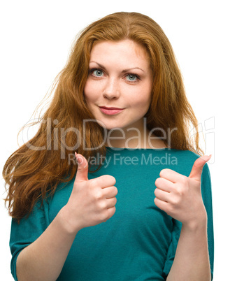 Woman is showing thumb up gesture