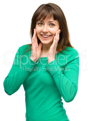 Woman is holding her face in astonishment