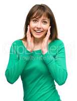 Woman is holding her face in astonishment