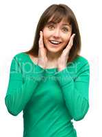 Woman is holding her face in astonishment