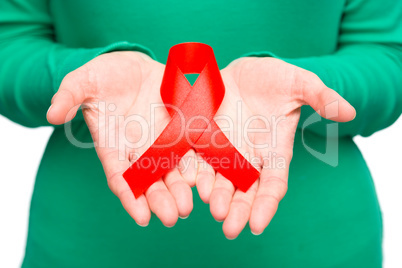 Woman is holding the red awareness ribbon