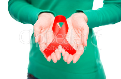 Woman is holding the red awareness ribbon