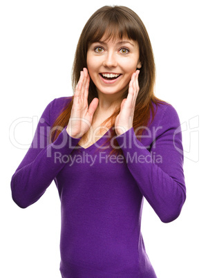 Woman is holding her face in astonishment