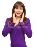 Woman is holding her face in astonishment