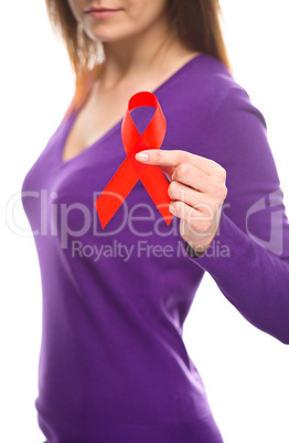 Woman is holding the red awareness ribbon