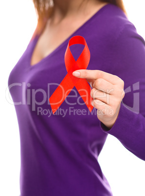 Woman is holding the red awareness ribbon