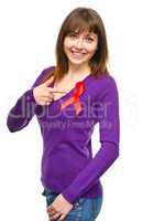 Woman is pointing to the red awareness ribbon