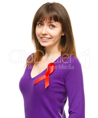 Woman with the red awareness ribbon