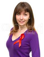 Woman with the red awareness ribbon