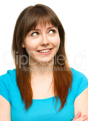 Young happy woman is looking up and smile Young happy woman is looking up and smile