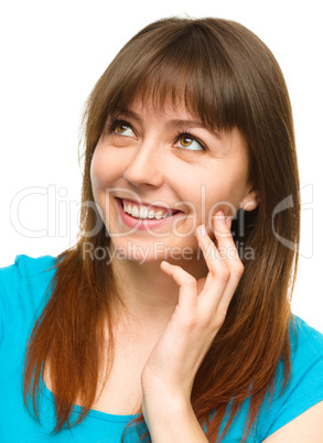 Young woman is touching her cheek with hand