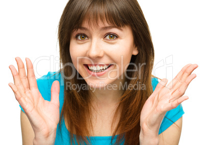 Portrait of a young woman raised her hands up