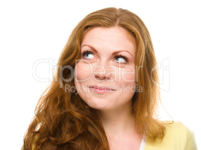 Young happy woman is looking up and smile