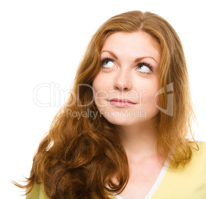 Young happy woman is looking up and smile