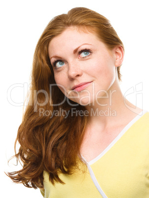 Young happy woman is looking up and smile