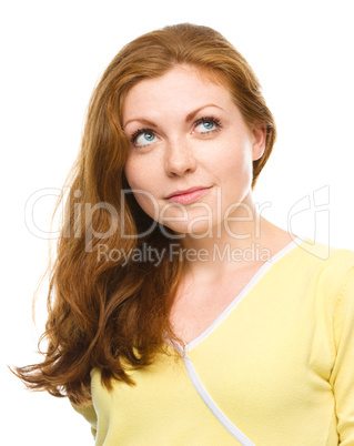 Young happy woman is looking up and smile