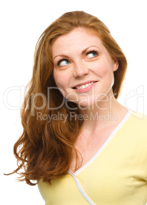 Young happy woman is looking up and smile