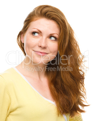 Young happy woman is looking up and smile