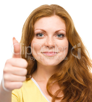 Woman is showing thumb up gesture