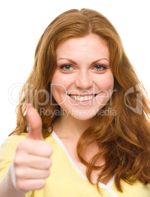 Woman is showing thumb up gesture