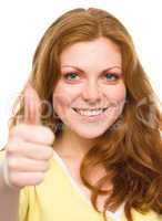 Woman is showing thumb up gesture