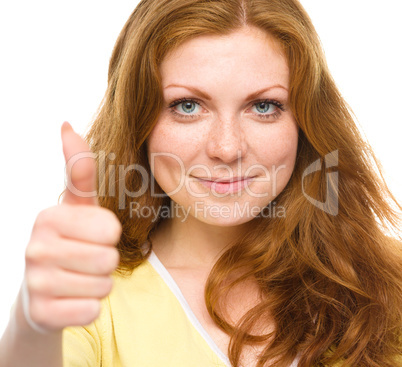 Woman is showing thumb up gesture