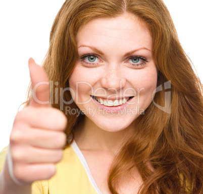 Woman is showing thumb up gesture