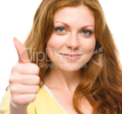 Woman is showing thumb up gesture