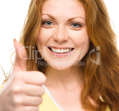 Woman is showing thumb up gesture