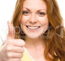 Woman is showing thumb up gesture