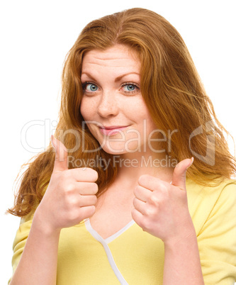 Woman is showing thumb up gesture