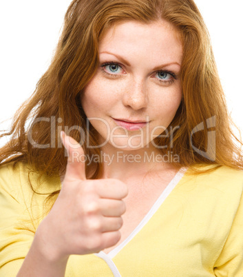 Woman is showing thumb up gesture