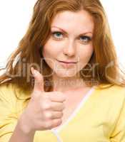 Woman is showing thumb up gesture