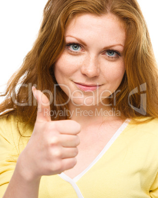 Woman is showing thumb up gesture