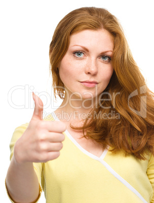 Woman is showing thumb up gesture